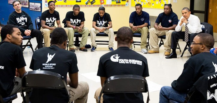 A group of young men from the Becoming a Man program at Chicago-based Youth Guidance sit in a circle discussing their lives with President Obama.