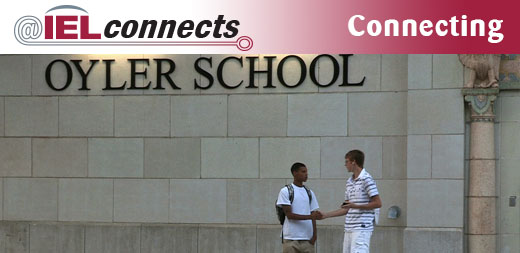 Two male high school students shake hands in front of Oyler Community Learning Center, a community school in Cincinnati.