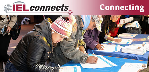 Community members sign up for groups at a Denver Public Schools family and community engagement event.