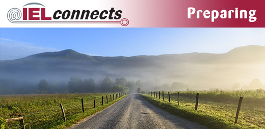 @IELconnects - Preparing: A gravel road stretches out to a misty mountain range in the distance.