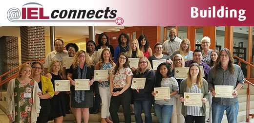 A diverse group of Ontario youth service professionals pose with their training certificates.