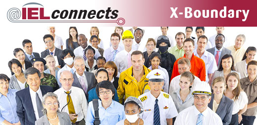 A large and diverse group of adults stand together dressed in the attire of different professions.
