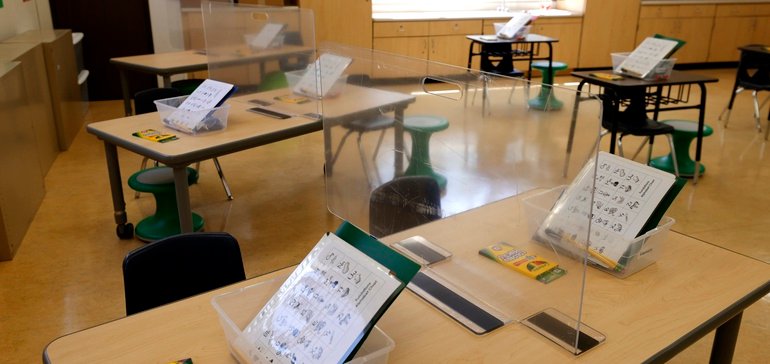 image of empty desks at school via Getty images