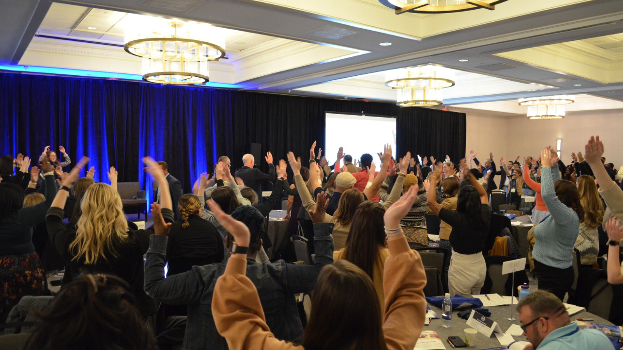 IEL conference attendees cheer