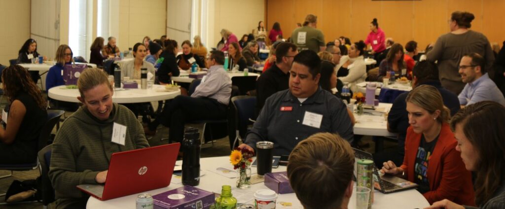 CO A large room filled with Community members gathered for the Ignite the Power of Us: Where Schools & Communities Shine conference