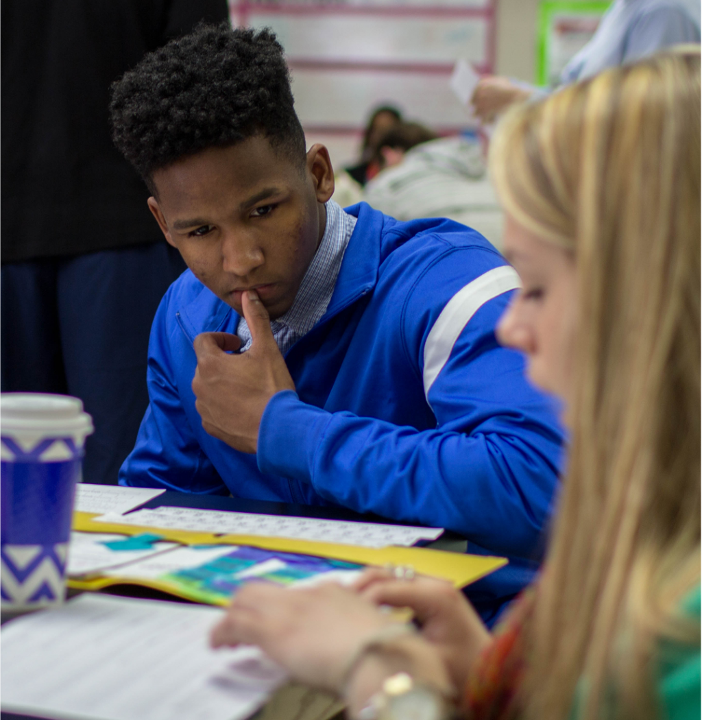 High school students work on classwork with each other